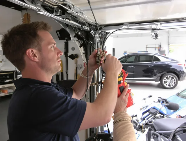 New Fairfield Garage Door Repair safety certified technician performing cable replacement in New Fairfield